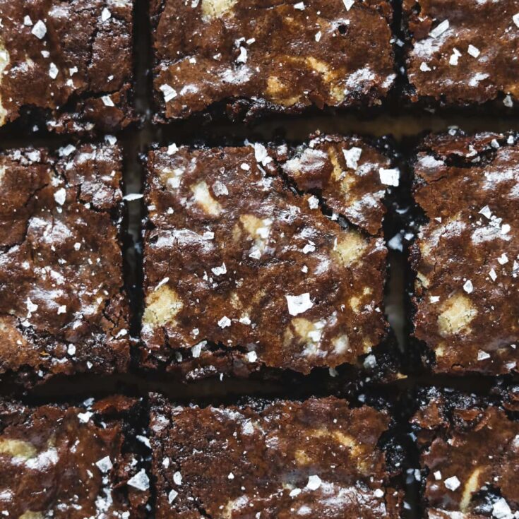 Nine browned butter brownie blondies on a white counter top.