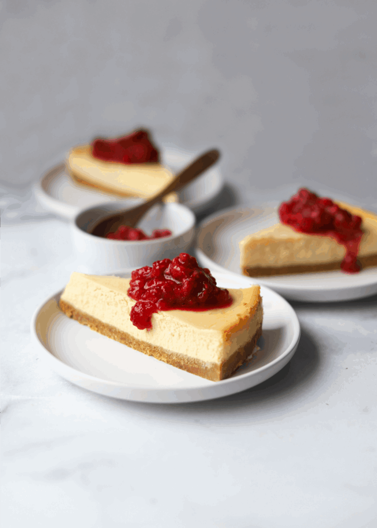 Three pieces of Italian ricotta cheesecake topped with raspberry sauce.